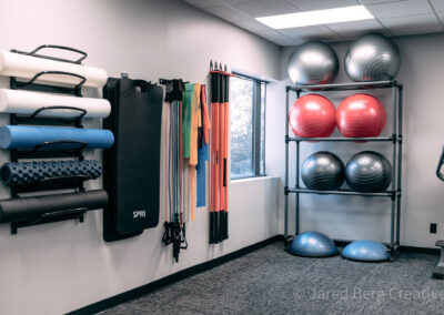 A gym with many different types of exercise equipment.