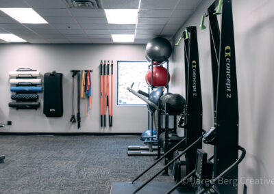 A gym with many different equipment in it