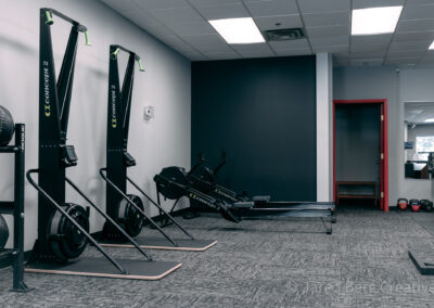 A room with several different types of exercise equipment.