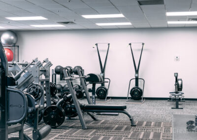 A gym with many different machines and equipment.