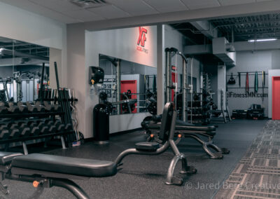 A gym with many machines and equipment in it