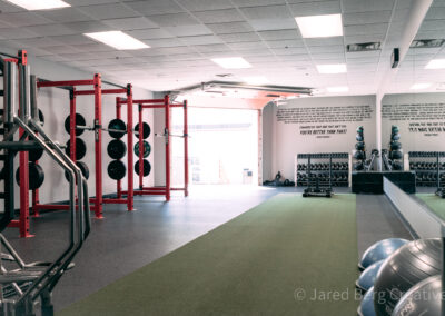 A gym with many equipment and a large window.