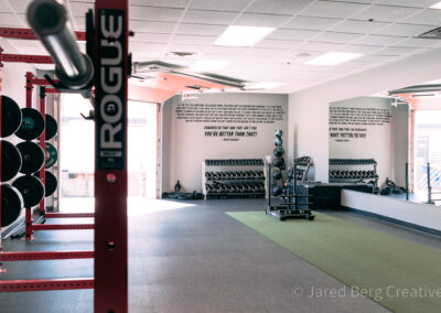 A gym with many machines and a ladder