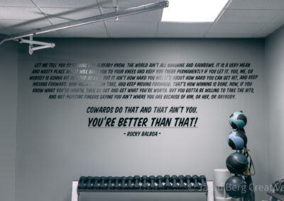 A gym with a wall that has some words on it