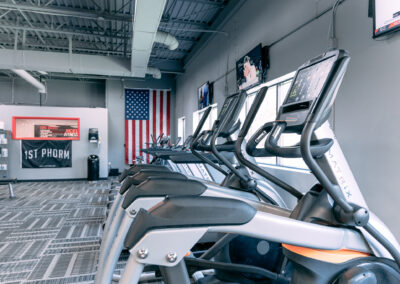 A row of exercise machines in a gym.