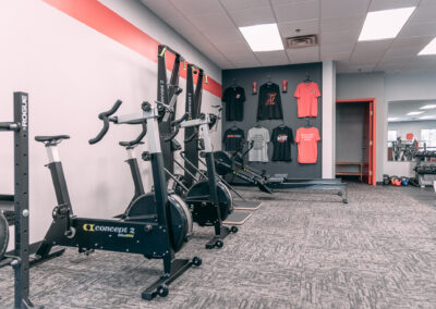 A gym with many different types of exercise equipment.