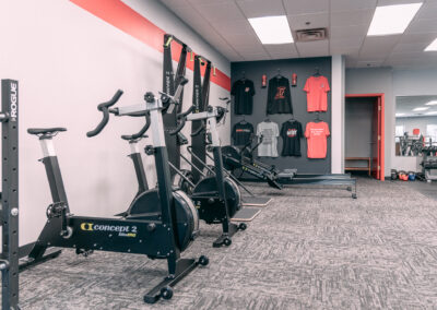 A gym with many different types of exercise equipment.