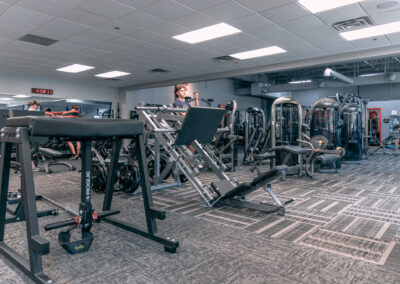 A gym with many machines and equipment in it