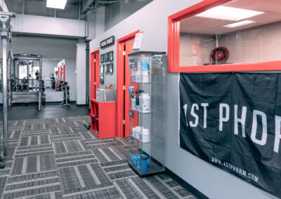 A hallway with red doors and a sign on the wall.